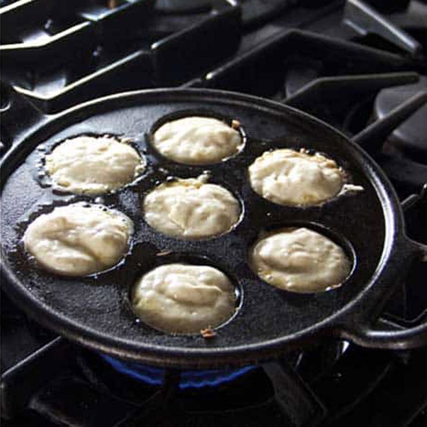 Show an aebleskiver pan with the holes all filled with batter