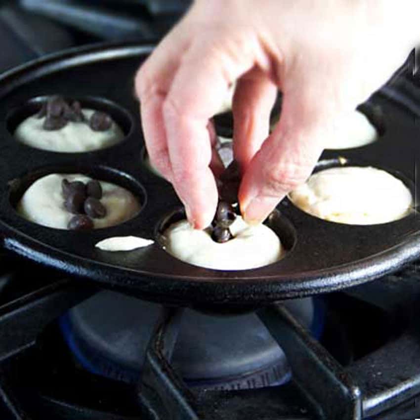 Show how to add a filling to the raw aebleskiver batter in the pan.