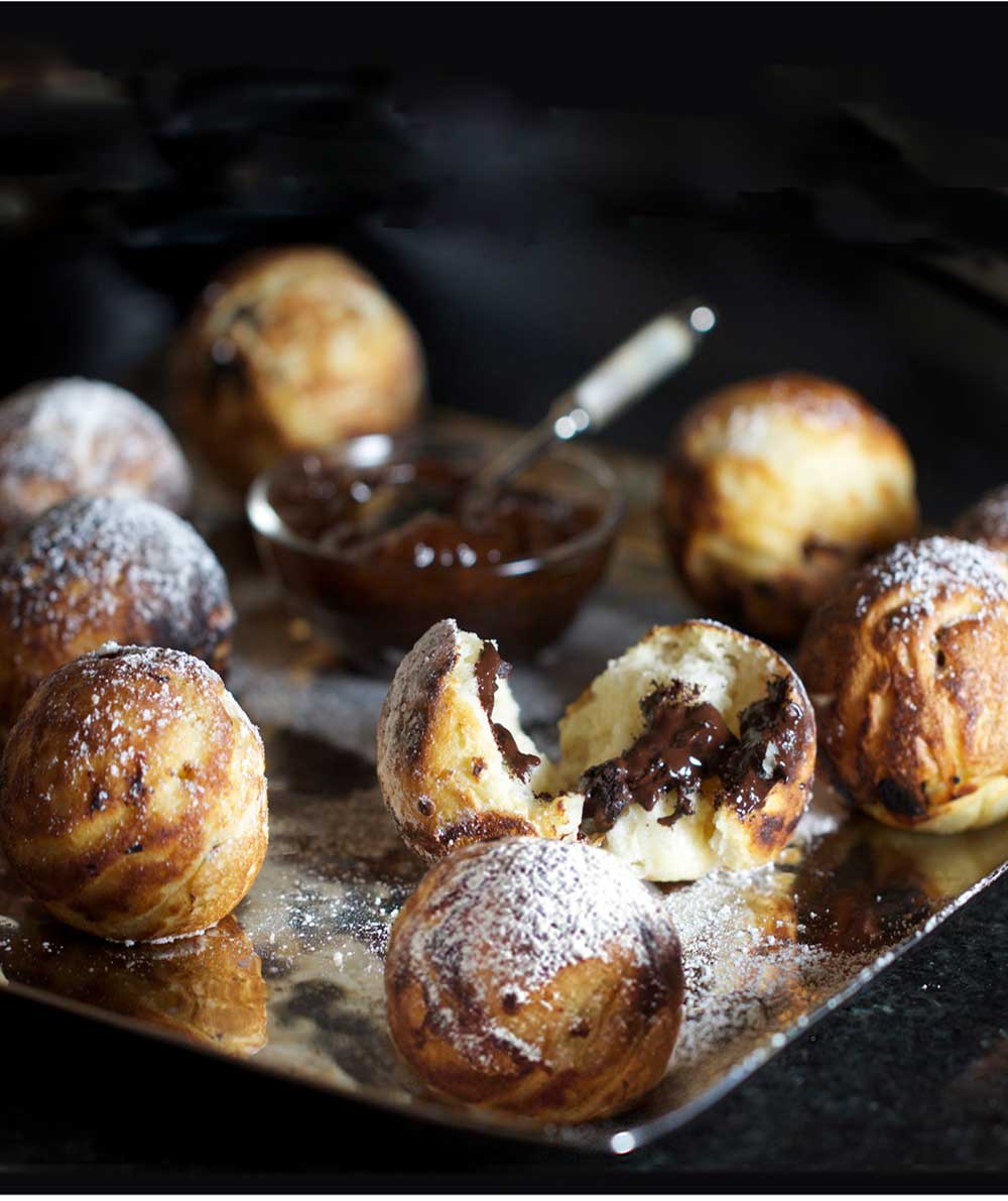 silver platter with chocolate filled aebleskiver pancake balls