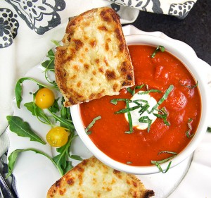 Grilled cheese with tomato soup is the ultimate comfort food pairing and the perfect lunch combo. Here's a special recipe for delicious spiced-up tomato soup and open-face oven grilled cheese with some special secret ingredients that make it extra tasty.