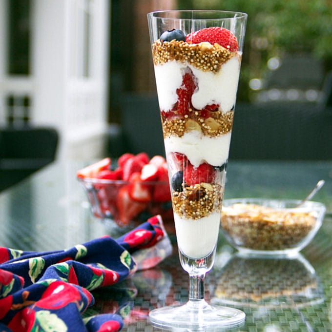 In this yogurt parfait recipe, toasted quinoa with coconut & almonds is a high protein, gluten-free alternative to granola. It's crunchy and nutty and the best thing ever to layer with creamy yogurt and fresh berries l www.panningtheglobe.com