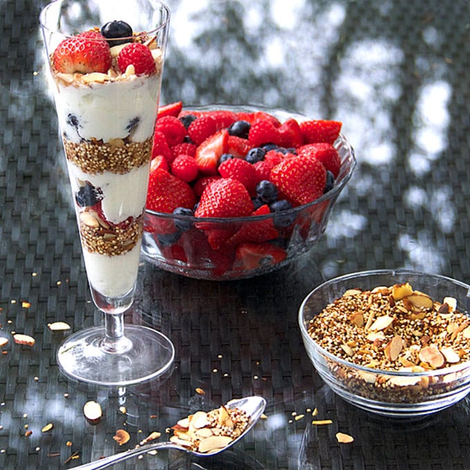 In this yogurt parfait recipe, toasted quinoa with coconut & almonds is a high protein, gluten-free alternative to granola. It's crunchy and nutty and the best thing ever to layer with creamy yogurt and fresh berries l www.panningtheglobe.com