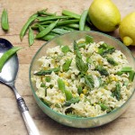 lemony frilly pasta with sugar snap peas and corn in a clear glass bowl