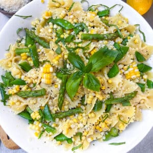 Butterfly pasta noodles mixed with asparagus, corn and snap peas