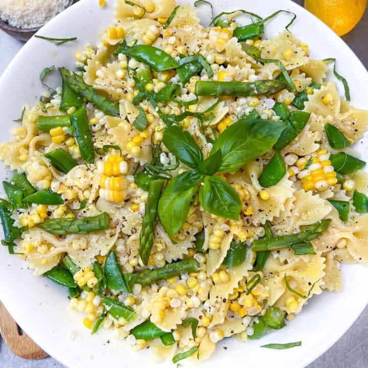 Butterfly pasta noodles mixed with asparagus, corn and snap peas