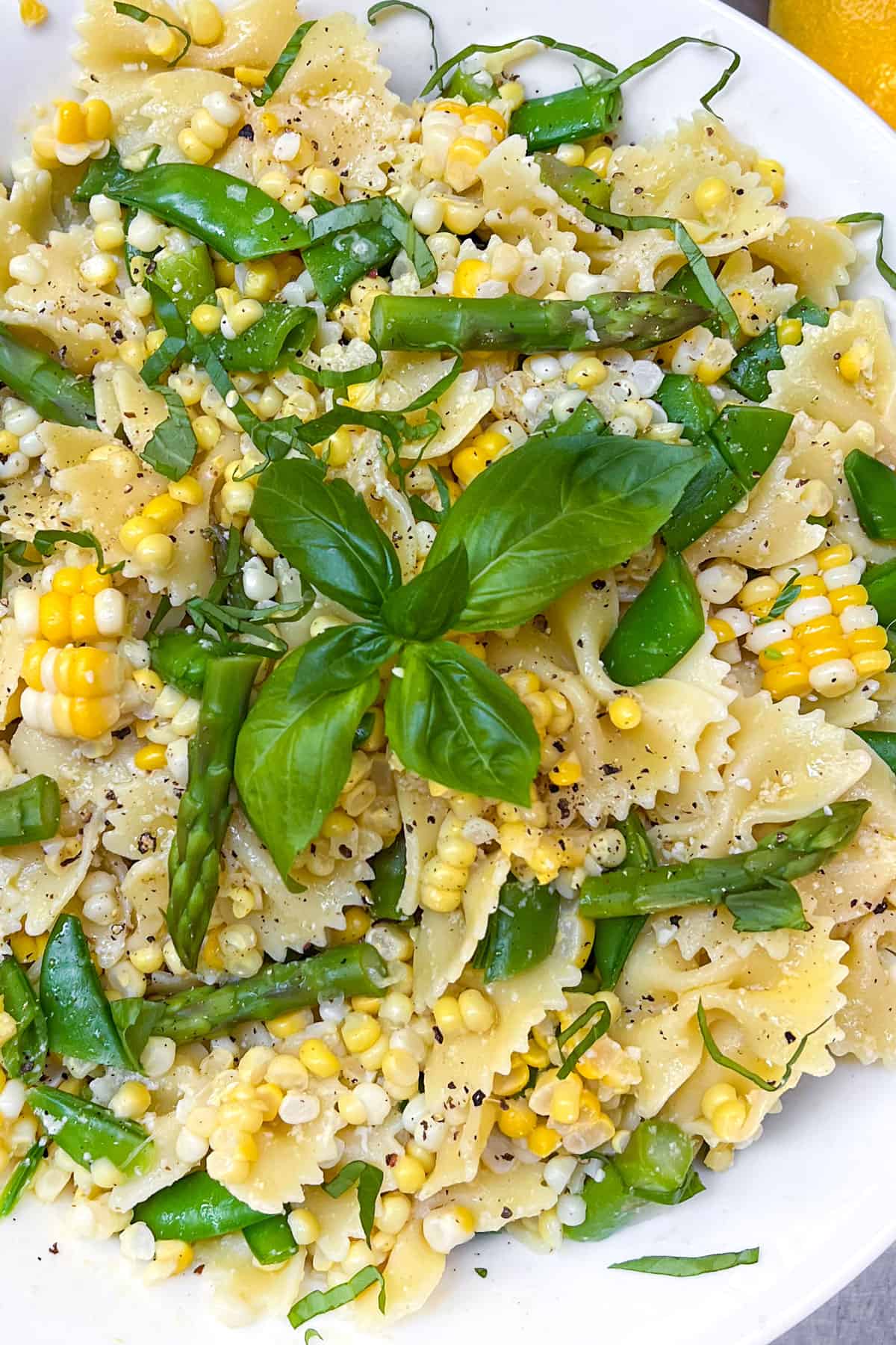 Butterfly pasta noodles mixed with asparagus, corn and snap peas
