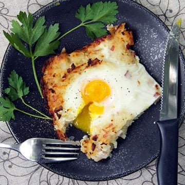 swiww rosti shredded potato casserole with soft cooked egg on top and a fork