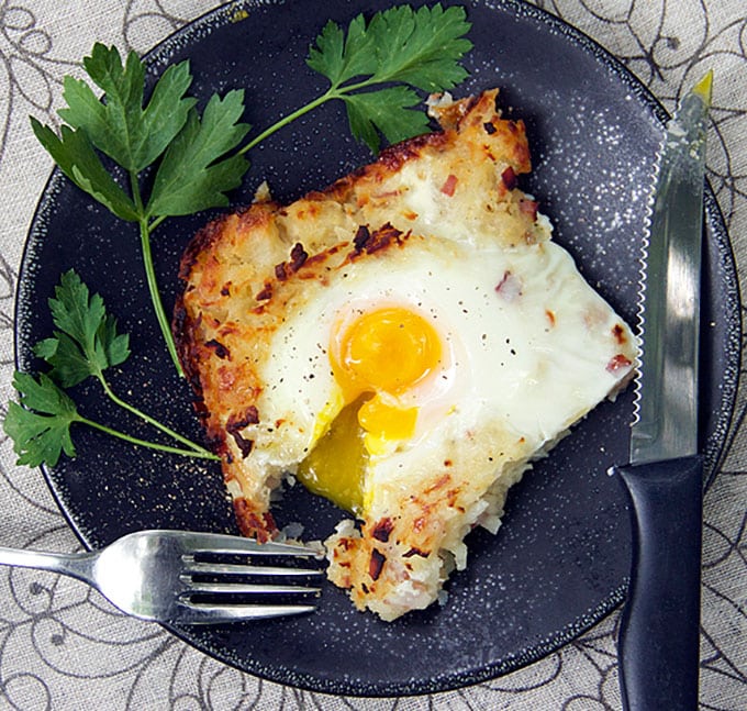 swiww rosti shredded potato casserole with soft cooked egg on top and a fork