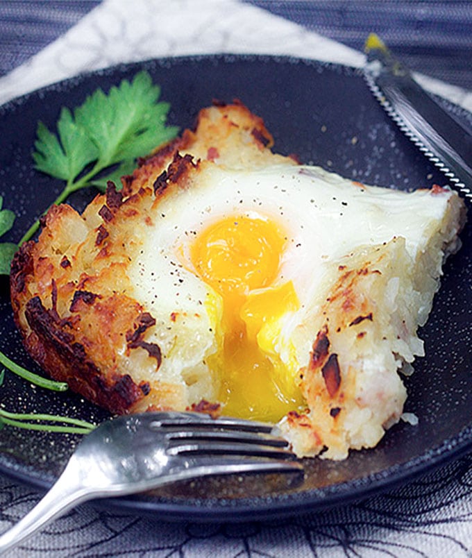 Swiss Rosti is a shredded potato casserole with ham, onions and cheese melted in, and soft-cooked eggs baked on top. It's the perfect brunch recipe, and you can do most of the prep ahead of time.