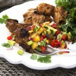 Mexican spiced grilled chicken and tropical salsa on a white plate