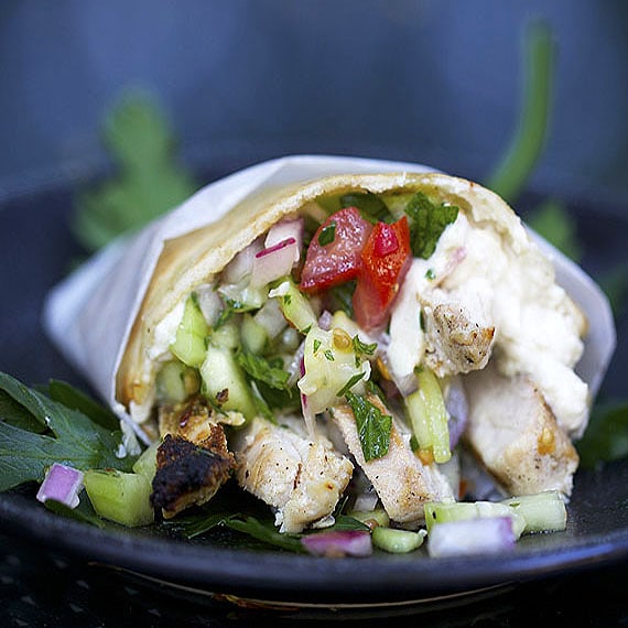 chicken shawarma rolled up in a tortilla with chopped salad