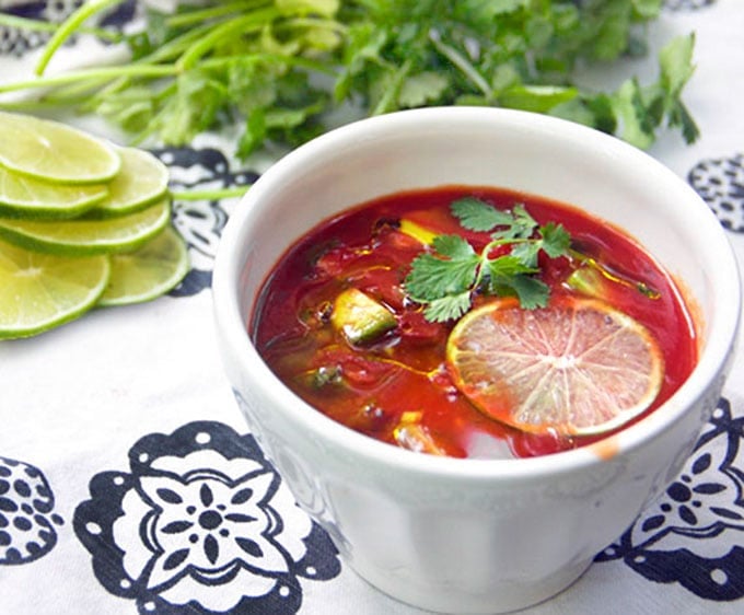 Spiced up tomato juice with cubed avocado, cilantro, garlic and lime juice makes the BEST quick and easy gazpacho! This delicious cold tomato soup is ready in 15 minutes. Ladle it into bowls and garnish with a generous drizzle of extra virgin olive oil and a thin slice of fresh lime.