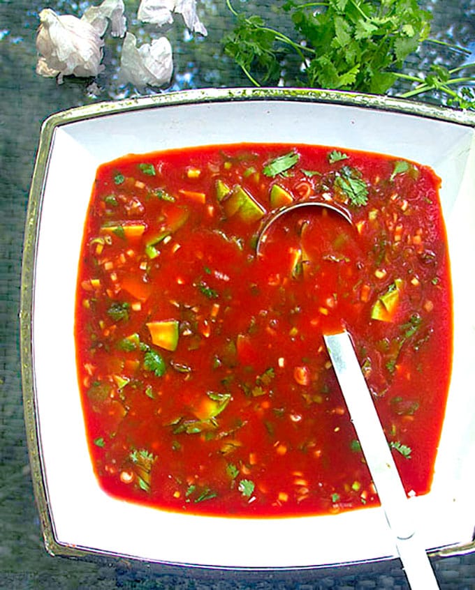 Spiced up tomato juice with cubed avocado, cilantro, garlic and lime juice makes the BEST quick and easy gazpacho! This delicious cold tomato soup is ready in 15 minutes. Ladle it into bowls and garnish with a generous drizzle of extra virgin olive oil and a thin slice of fresh lime.