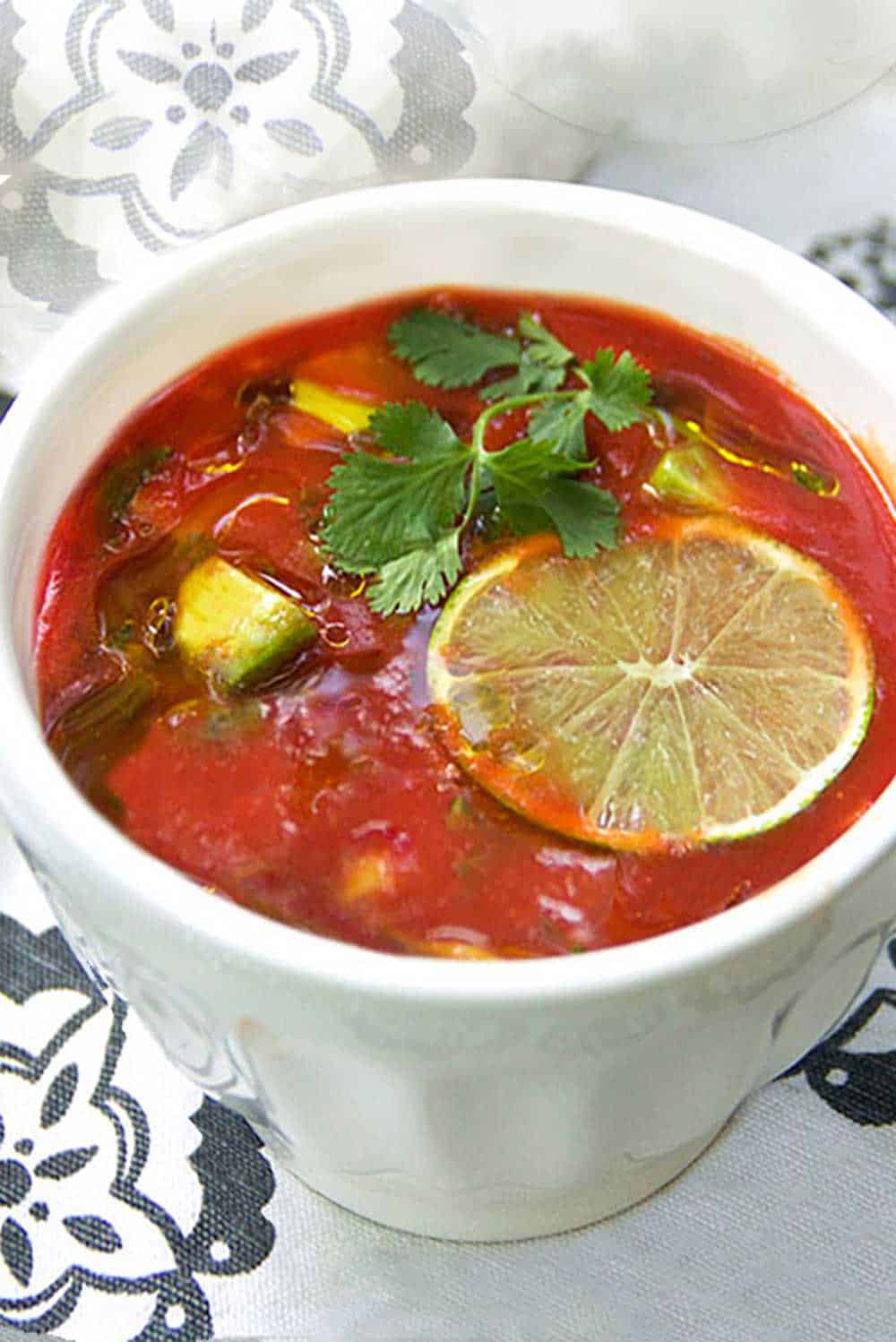 Spiced up tomato juice with cubed avocado, cilantro, garlic and lime juice makes the BEST quick and easy gazpacho! This delicious cold tomato soup is ready in 15 minutes. Ladle it into bowls and garnish with a generous drizzle of extra virgin olive oil and a thin slice of fresh lime.