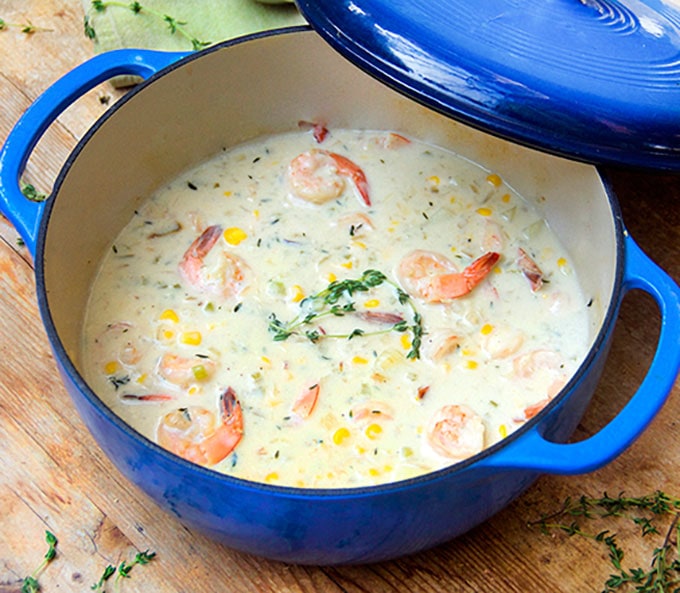 This scrumptious lightened-up shrimp and corn chowder is creamy with no cream at all. The base is chicken stock and low-fat milk…and there’s just enough butter and bacon to make it taste decadent l www.panningtheglobe.com 