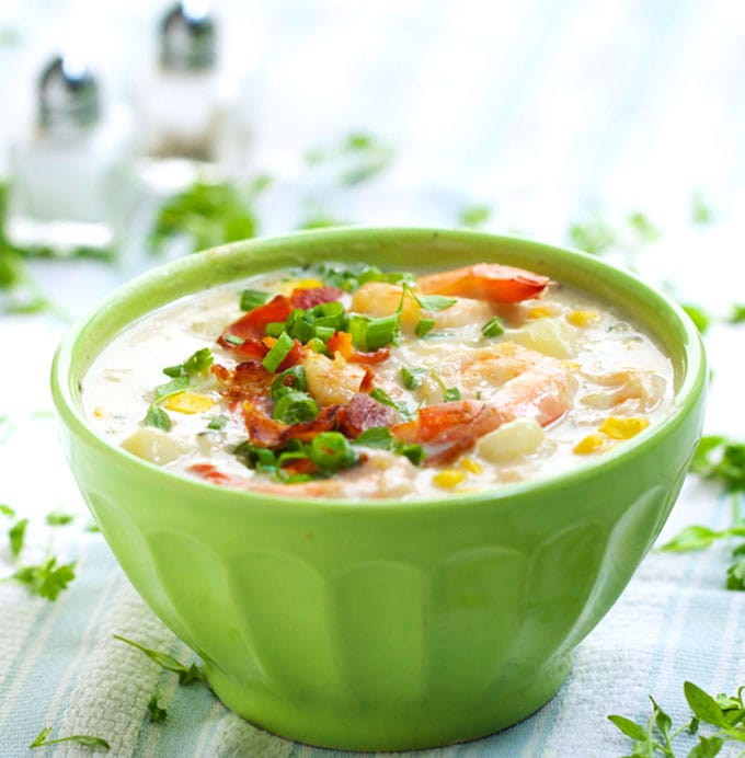 This scrumptious lightened-up shrimp and corn chowder is creamy with no cream at all. The base is chicken stock and low-fat milk…and there’s just enough butter and bacon to make it taste decadent l www.panningtheglobe.com 