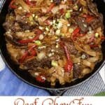 Beef chow fun noodles in a cast iron pan