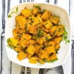 cubes of roasted butternut squash in a white bowl