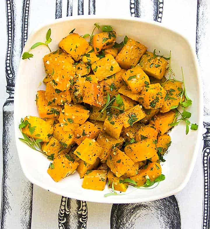 cubes of roasted butternut squash in a white bowl