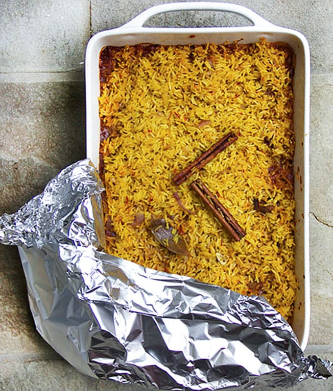 lamb biryani casserole with tin foil partially pulled back.