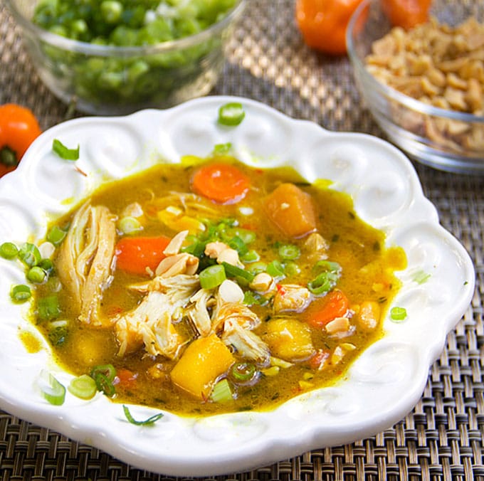 Jamaican Curried Chicken with shredded chicken and cubes of butternut squash simmered in coconut curry broth, with rum and mango. 