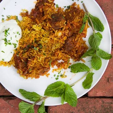 Indian Lamb Biryani: Sumptuous casserole of tender lamb curry with saffron spiced rice with cucumber-mint raita on the side|Panning The Globe