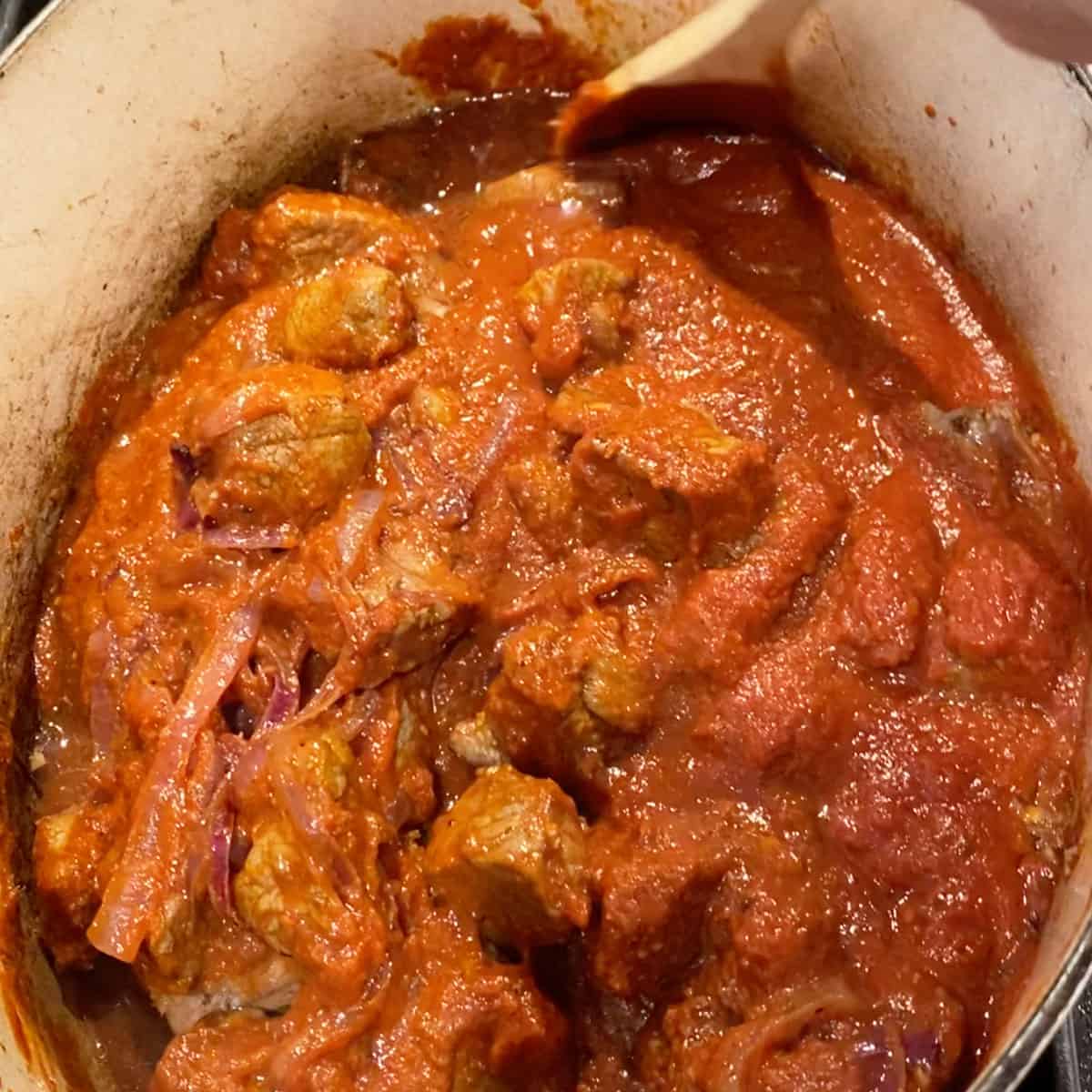 lamb curry simmering in a dutch oven.