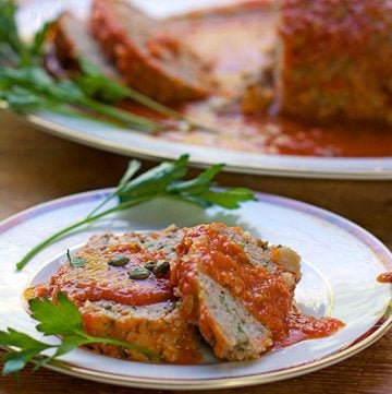 This Sicilian Turkey Meatloaf is unique and incredibly delicious: ground turkey mixed with mashed potatoes and simmered in wine-scented tomato sauce.