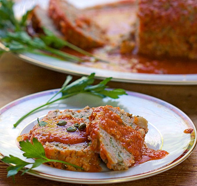 This Sicilian Turkey Meatloaf is extra tender and delicious because the ground turkey is mixed with mashed potatoes (instead of breadcrumbs) and then simmered in wine-scented tomato sauce. 