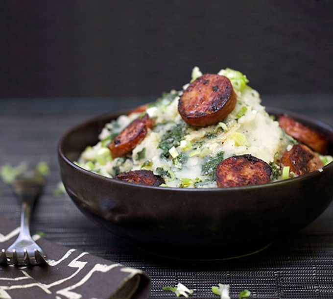 Dutch Stamppot is comfort food of the Netherlands. Kale mashed potatoes, topped with smoky sausages. A perfect hearty fall or winter meal.