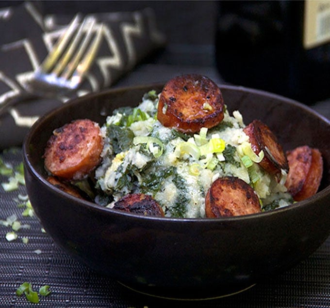 Dutch Stamppot is comfort food of the Netherlands. Kale mashed potatoes, topped with smoky sausages. A perfect hearty fall or winter meal.