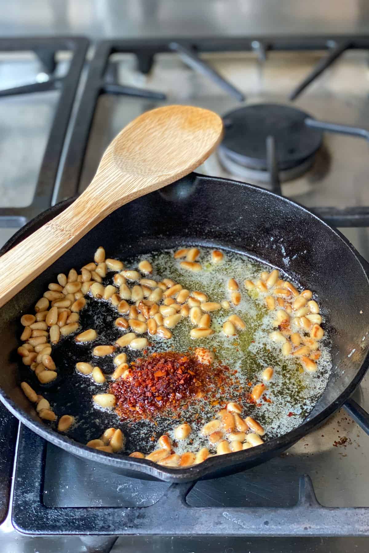 cast iron skillet with toasted pine nuts, butter and Aleppo pepper