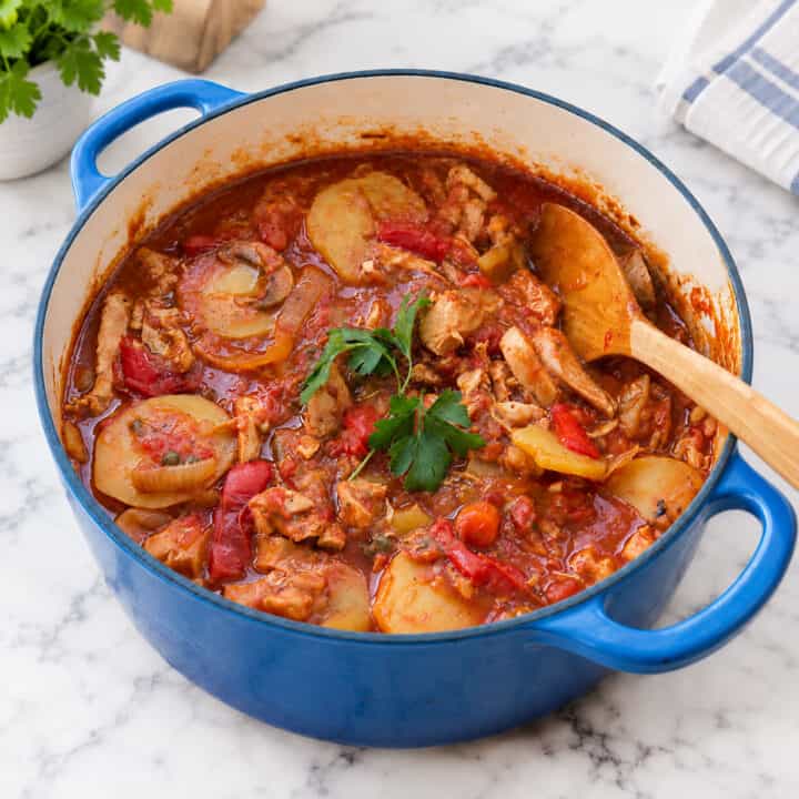 Chicken cacciatore in a blue dutch oven.