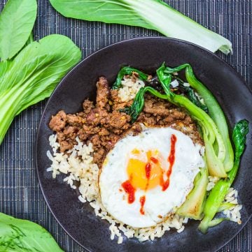 It takes just 20 minutes to make this super flavorful, healthy dinner recipe: Thai Beef Bok Choy Rice Bowl with an egg on top. Add your favorite hot sauce!