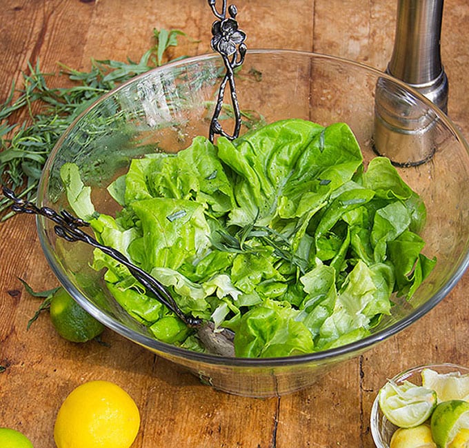 Butter Lettuce Salad with Citrus Honey Vinaigrette in a glass bowl on a wooden table