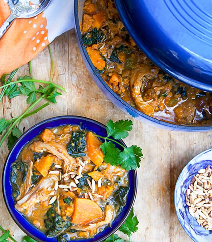 This Moroccan Chicken Stew is a one-pot dinner with fall-apart tender chicken thighs, sweet potatoes, dried apricots and kale, oven-braised in chicken broth and aromatic spices. [paleo] [gluten-free, dairy-free] l panningtheglobe.com