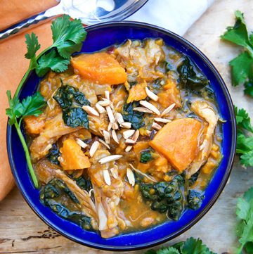 This Moroccan Chicken Stew is a one-pot dinner with fall-apart tender chicken thighs, sweet potatoes, dried apricots and kale, oven-braised in chicken broth and aromatic spices. [paleo] [gluten-free, dairy-free] l panningtheglobe.com