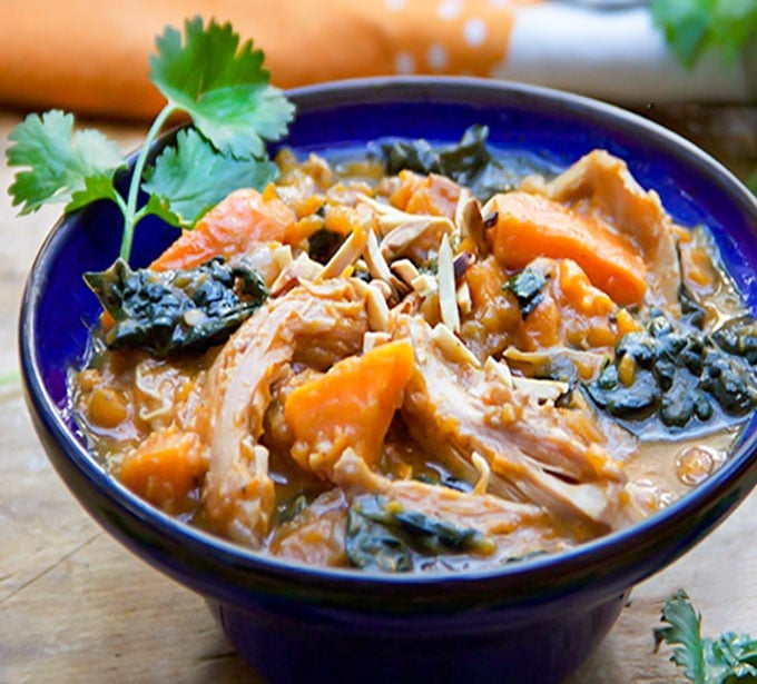 This Moroccan Chicken Stew is a one-pot dinner with fall-apart tender chicken thighs, sweet potatoes, dried apricots and kale, oven-braised in chicken broth and aromatic spices. [paleo] [gluten-free, dairy-free] l panningtheglobe.com