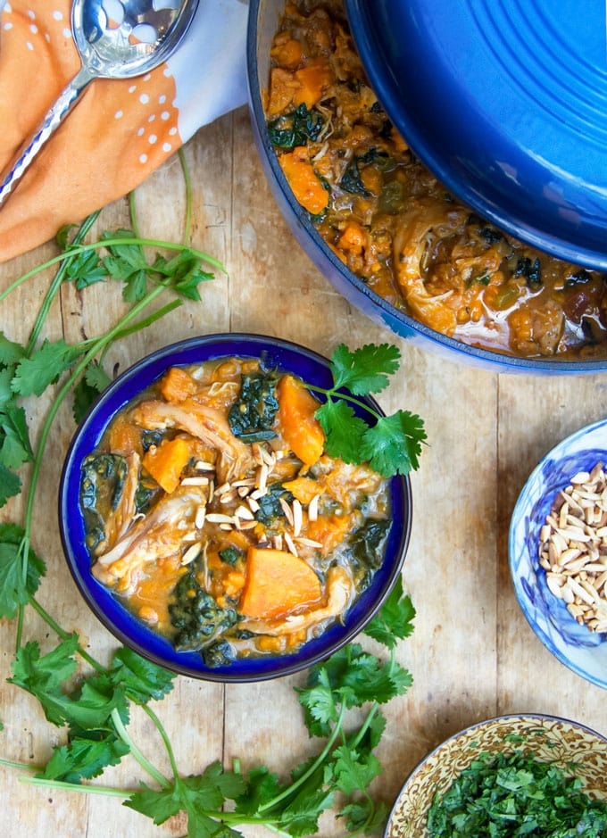 This Moroccan Chicken Stew is a one-pot dinner with fall-apart tender chicken thighs, sweet potatoes, dried apricots and kale, oven-braised in chicken broth and aromatic spices. [paleo] [gluten-free, dairy-free] l panningtheglobe.com 