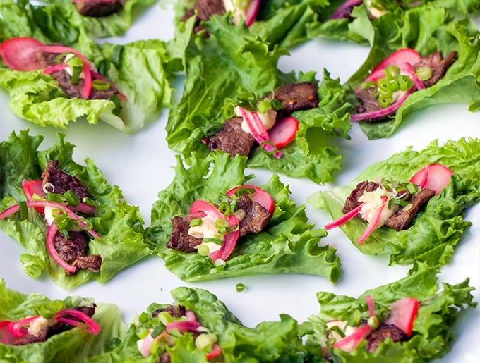 These Korean Beef Lettuce Wraps are an explosion of flavor. Famously delicious Korean Bulgogi beef wrapped up in lettuce leaves with homemade picked onions and radishes and miso mayonnaise. Serve as an appetizer or main dish l Panning The Globe Recipe