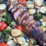 Pinterest image: sliced roasted pork tenderloin on a sheet pan surrounded by sliced roasted potatoes, roasted cherry tomatoes and roasted broccoli