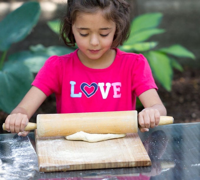 rolling out the dough for pizza