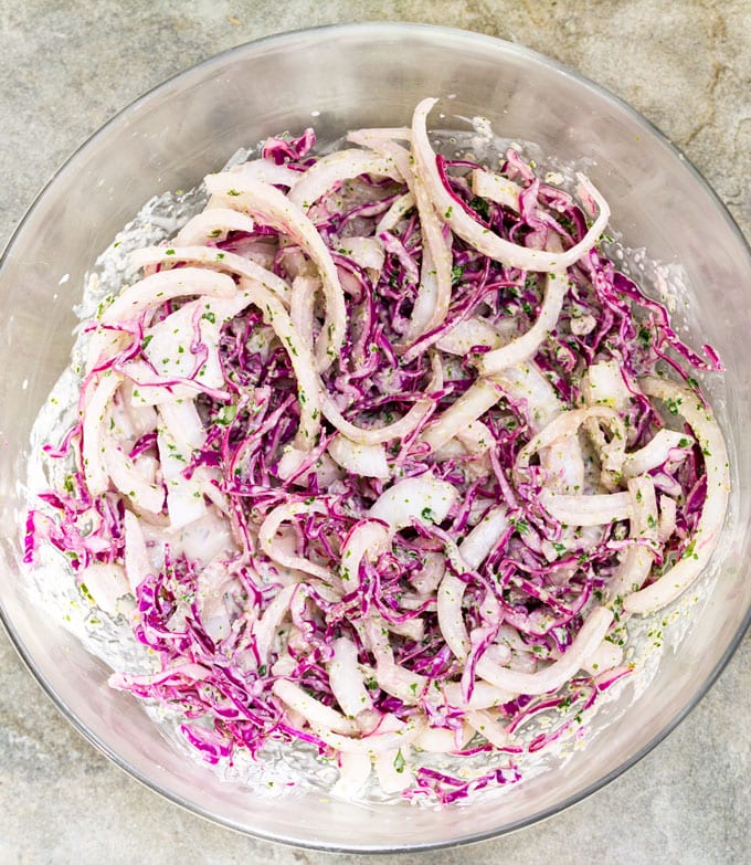 Cabbage onions slaw in a glass bowl