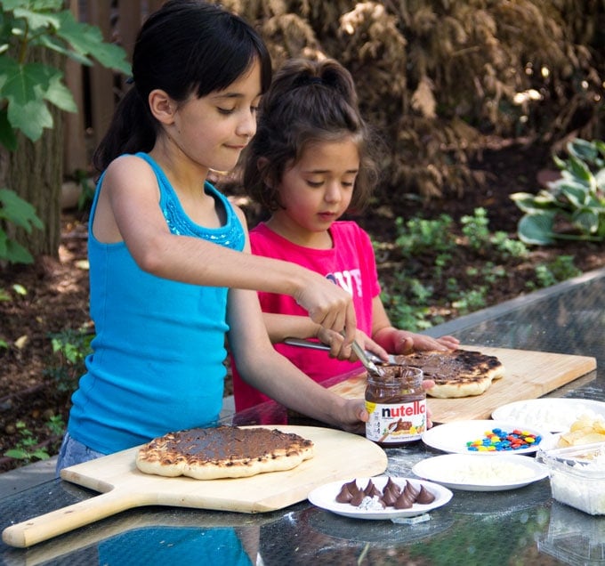 Spreading the chocolate on the pizza