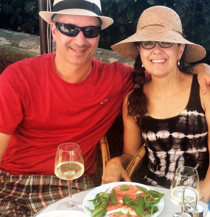 Ed and Lisa Goldfinger sitting at a restaurant on the Isle of Capri, eating a caprese salad and drinking white wine