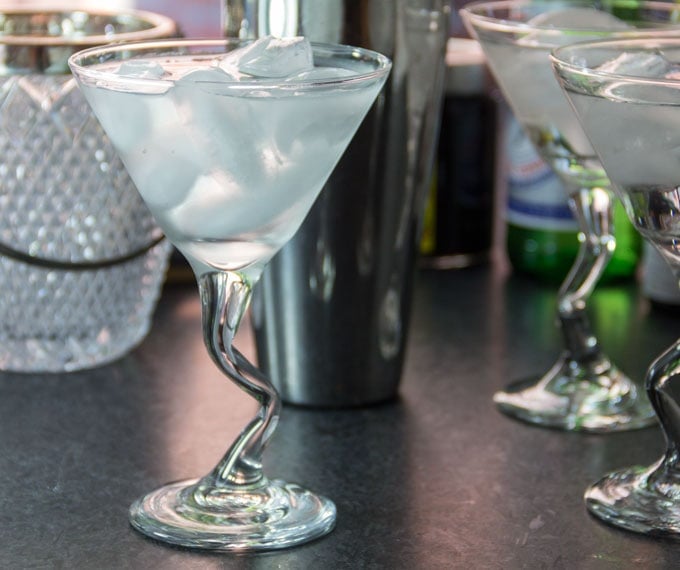 martini glasses are chilled with ice water