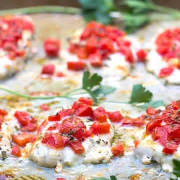 chicken cutlets topped with fresh tomatoes and two cheeses