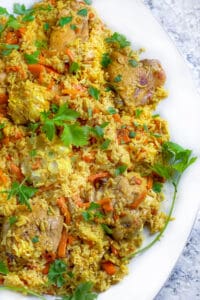 close up of a platter of chicken plov, chicken and rice casserole