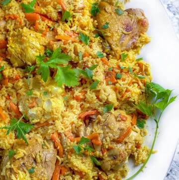 close up of a platter of chicken plov, chicken and rice casserole