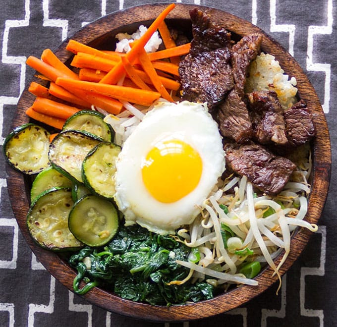 Bibimbap • Korean rice bowl with marinated beef, seasoned vegetables, fried egg and delicious spicy sauce • Panning The Globe